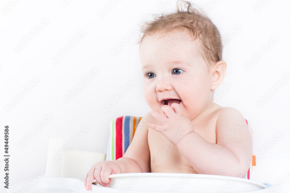 Cute baby sitting in a high chair waiting for dinner Cute baby sitting in a high chair waiting for dinner
