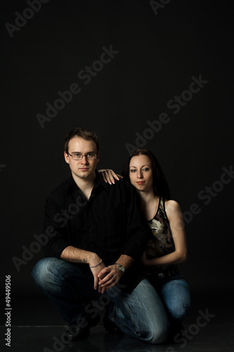 handsome young couple posing sitting in studio © Radnatt