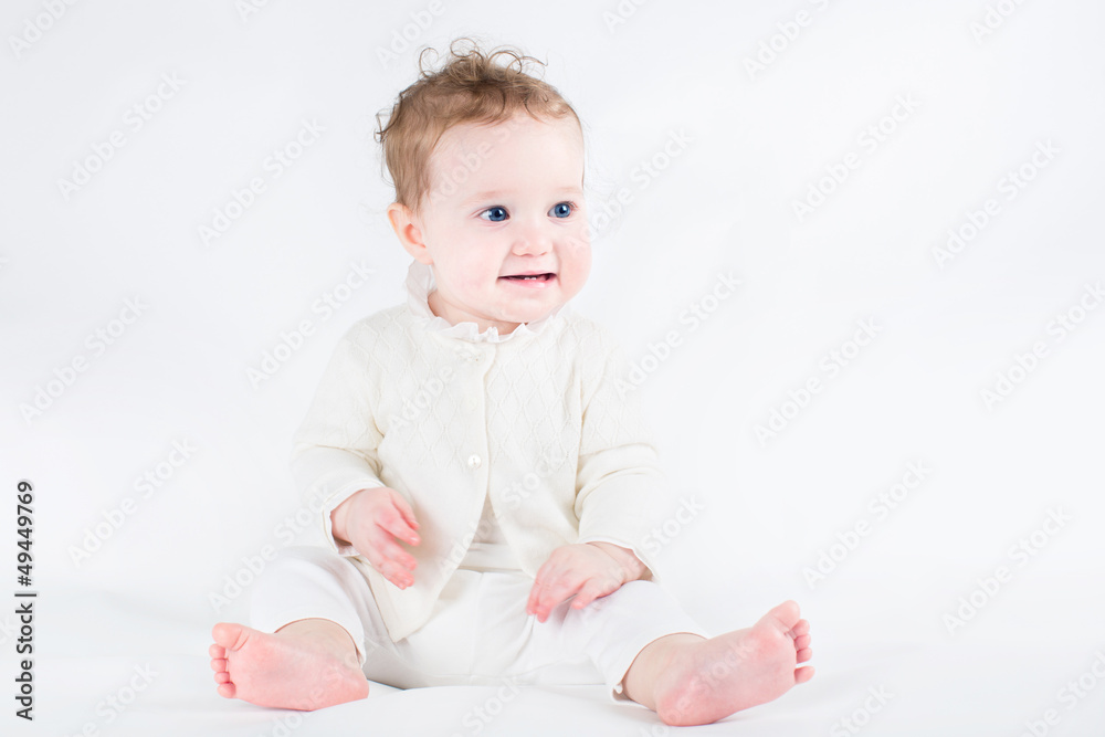 Adorable baby girl wearing white sweater