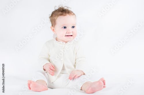 Adorable baby girl wearing white sweater