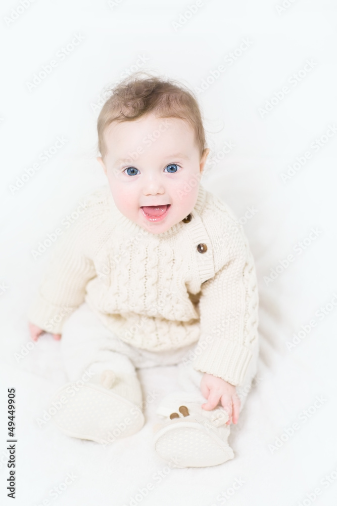 Funny baby in a warm cable knit sweater and boots Funny baby in a warm cable knit sweater and boots