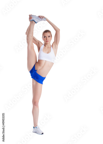 Flexible young woman in shorts and top