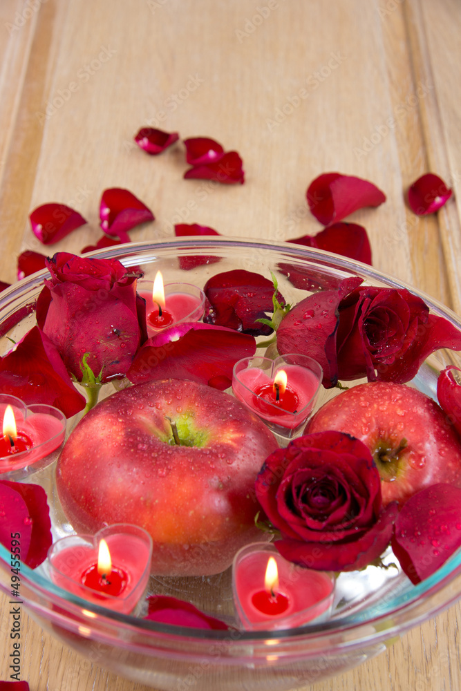 Valentine apple with rose petals and heart candles