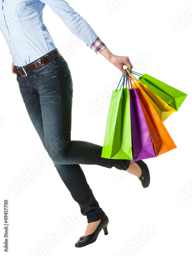 Attractive girl holding multicolored shopping paper bags