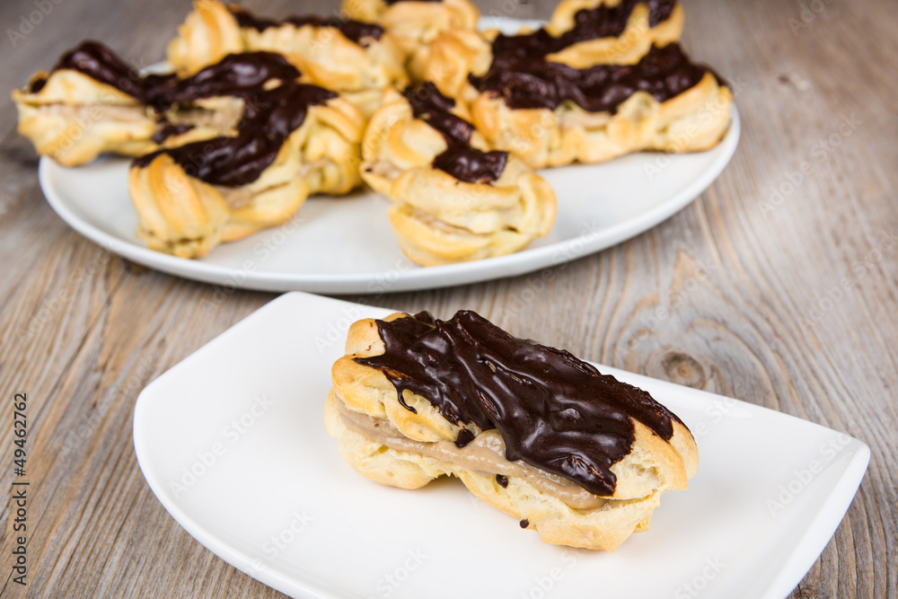 Fresh eclairs with coffee cream inside and chocolate Fresh eclairs with coffee cream inside and chocolate