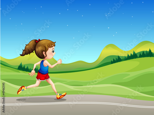 A girl running in the street near the hills