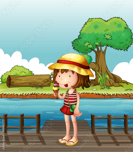 A girl eating an ice cream at the bridge