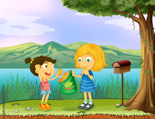 A girl sharing her bread near a mailbox