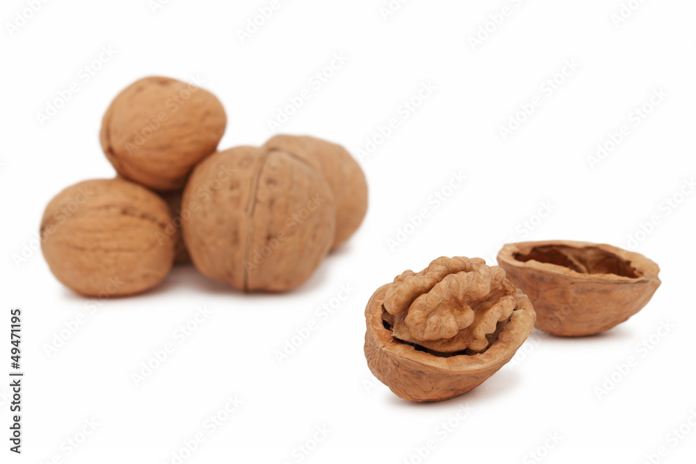 Several full and cracked walnuts (isolated) Several full and cracked walnuts (isolated)