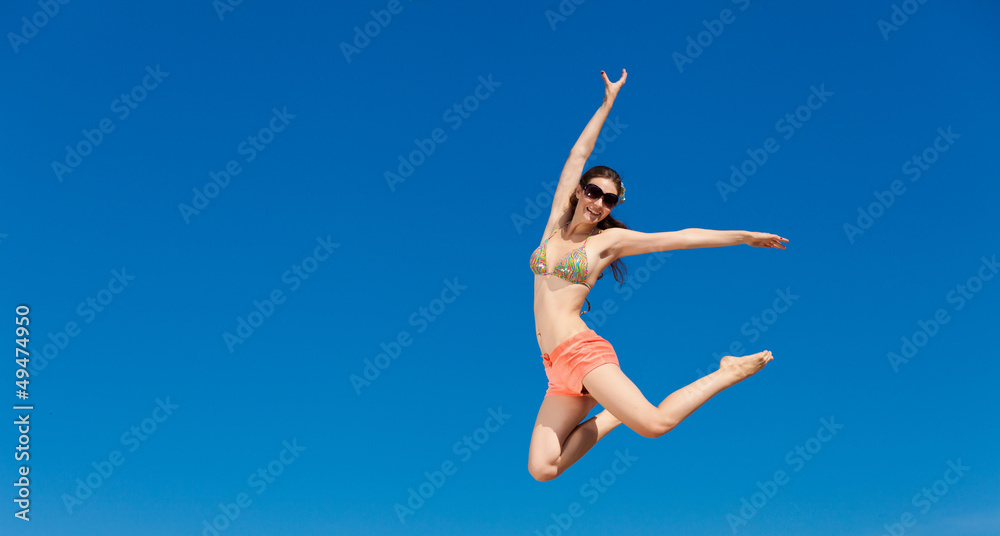 Portrait of young woman in bikini at beach