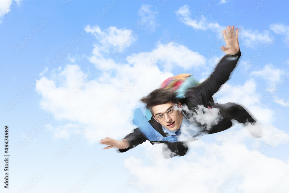 Young businessman flying with parachute on back Young businessman flying with parachute on back