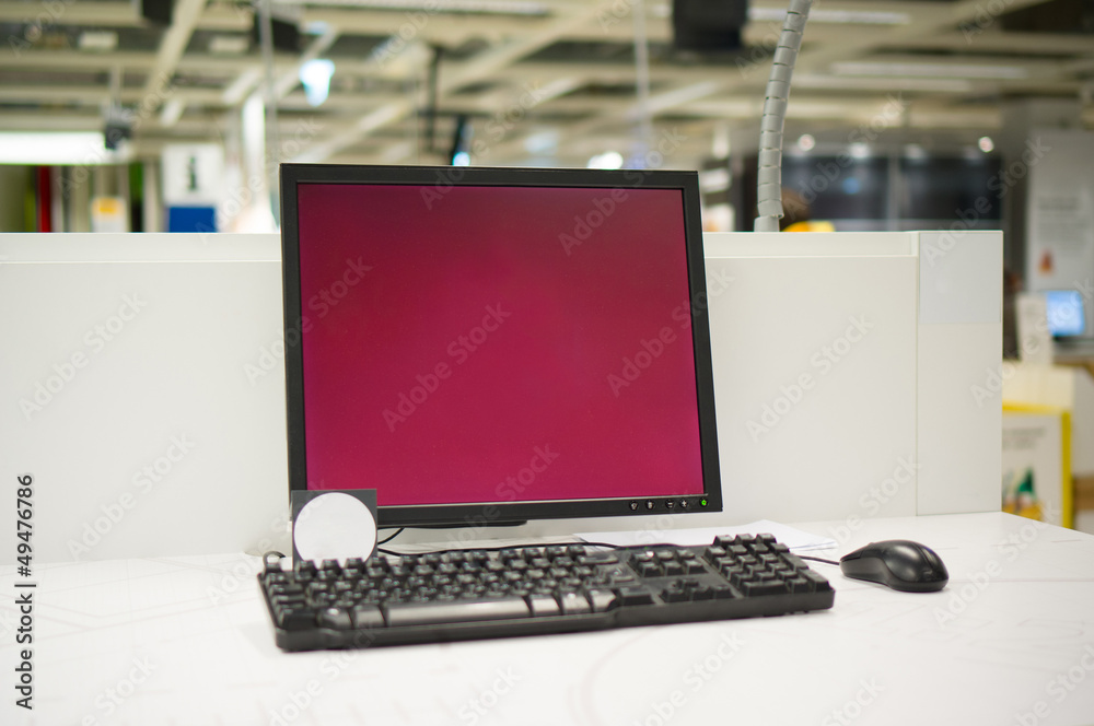 Computer information terminal with keyboard on table in store