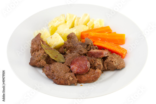 fried meat with sausages, potato and carrot photo