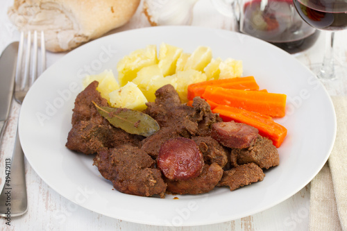 meat with sausage and potato with carrot photo
