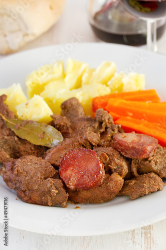 fried meat with sausages and boiled vegetables photo