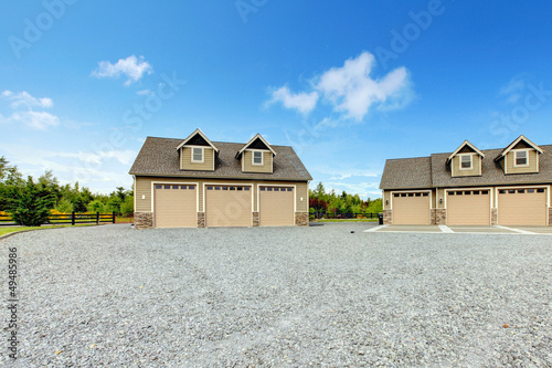 Large farm country house with gravel driveway photo
