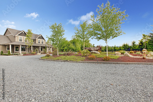 Large farm country house with gravel driveway