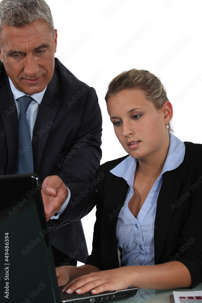 Boss and employee in front of laptop computer Boss and employee in front of laptop computer
