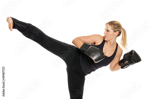 Female kickboxer doing a side kick isolated on white photo