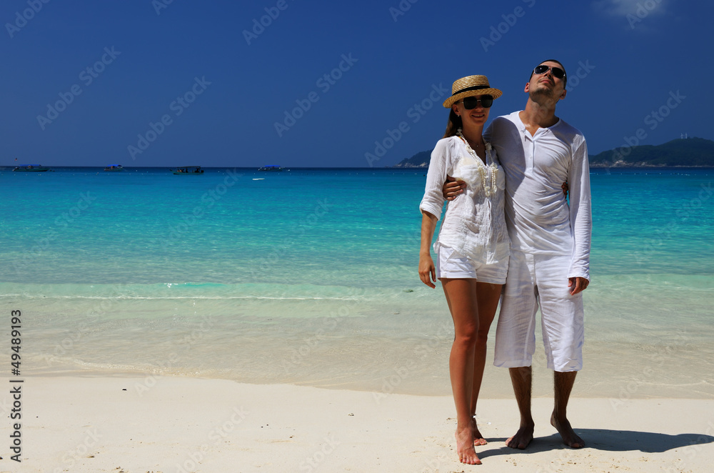 Couple in white on a beach Couple in white on a beach