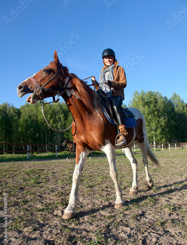 A woman riding a horse