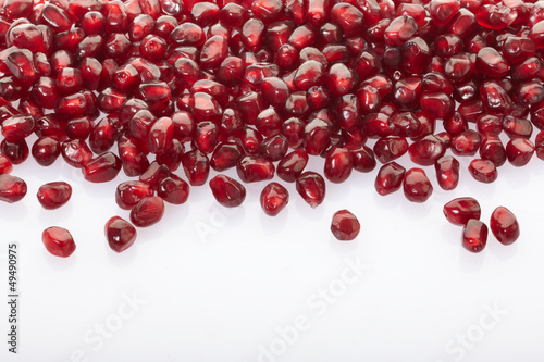 Pomegranate seed border on white background, body care