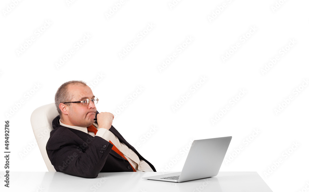 buisnessman sitting at desk and looking laptop with copy space buisnessman sitting at desk and looking laptop with copy space