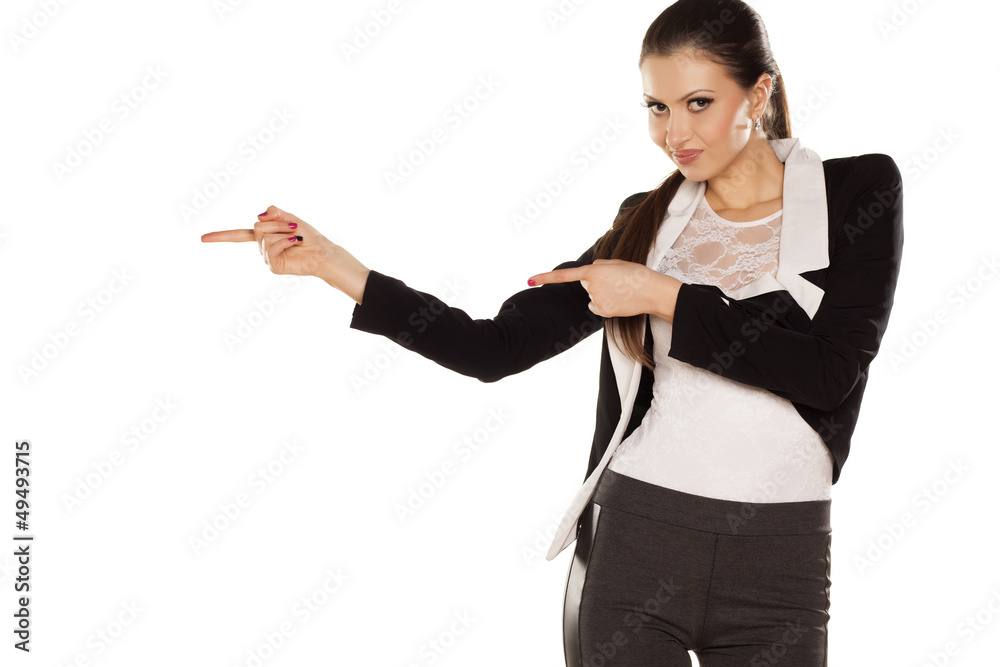smiling brunette shows the direction with both hands smiling brunette shows the direction with both hands
