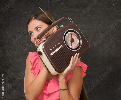 Portrait Of Happy Woman Holding Radio photo