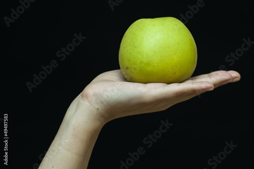 Female hand with a green apple