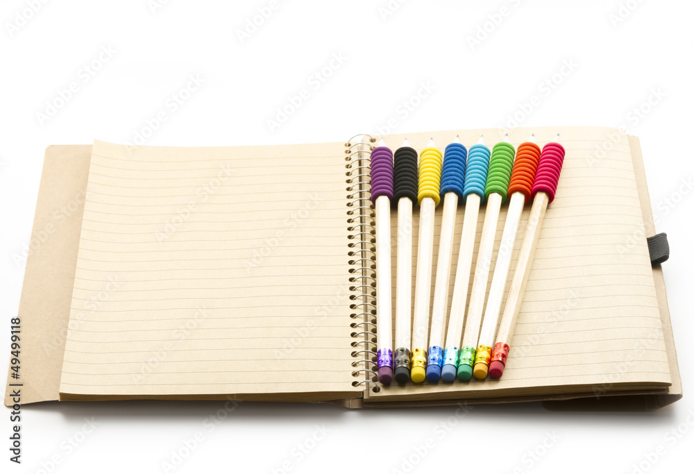 Fototapeta premium pencils on notebook