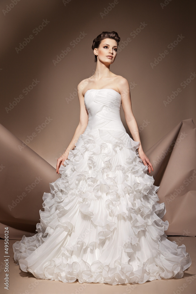 The beautiful young woman in a wedding dress