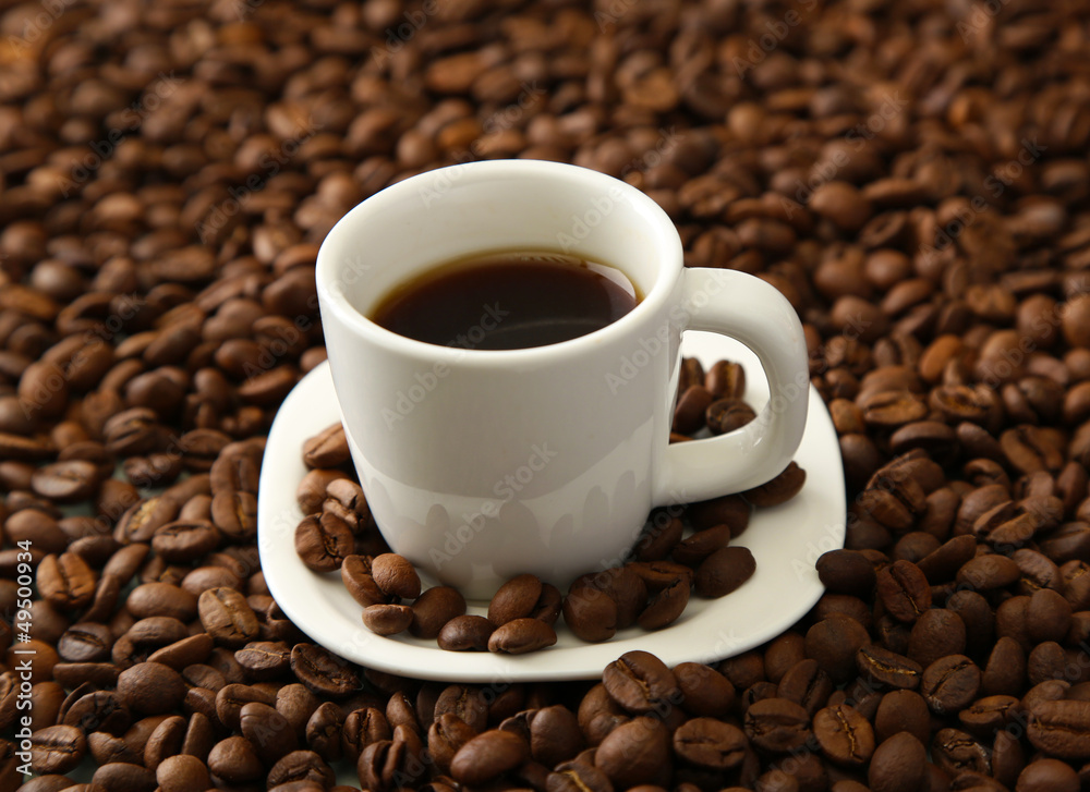 Cup of coffee on coffee beans background Cup of coffee on coffee beans background