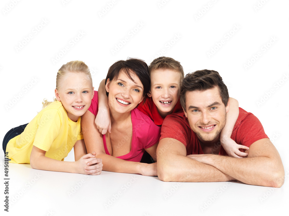 happy family with two children lying on white floor happy family with two children lying on white floor