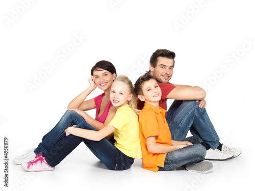 happy family with two children sitting on white floor