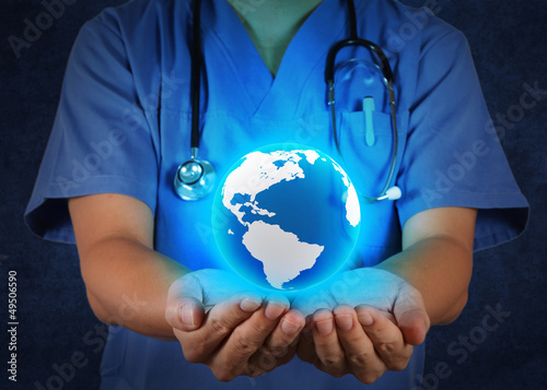 Fototapeta Naklejka Na Ścianę i Meble -  Medical Doctor holding a world globe in his hands as medical net