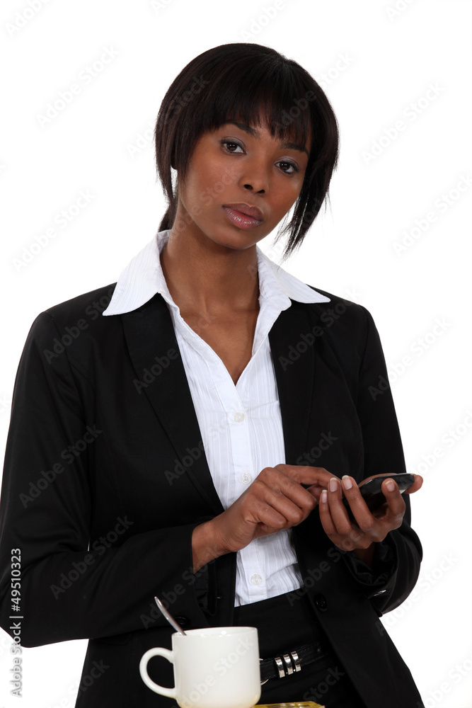 Businesswoman tapping a cellphone Businesswoman tapping a cellphone
