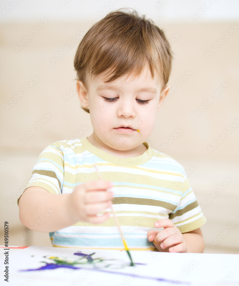 Little boy is playing with paints Little boy is playing with paints
