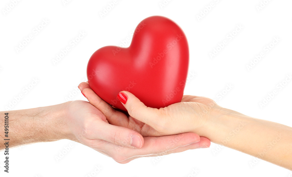 Red heart in woman and man hands, isolated on white