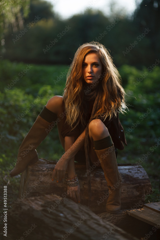 sexy Young Woman sitting on log posing sexy Young Woman sitting on log posing