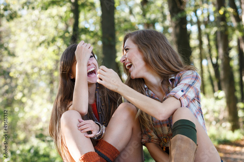 two girlfriends outdoor laughing