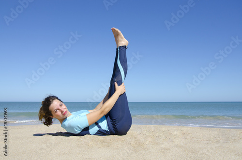 Sexy girl gymnastics at a tropical beach