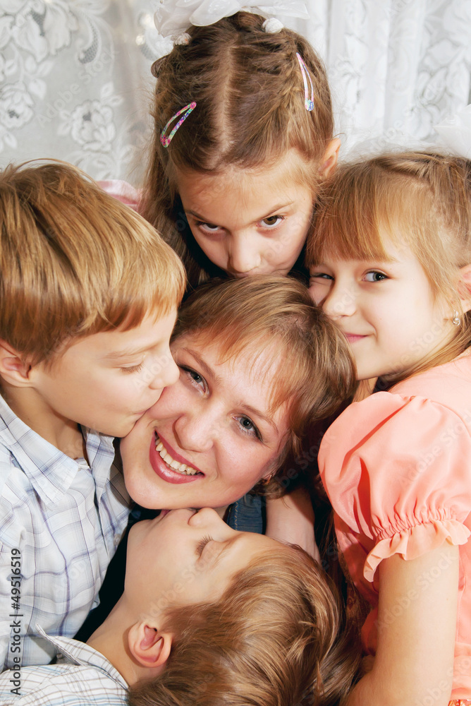 Four children kissing mother. Family concept Four children kissing mother. Family concept