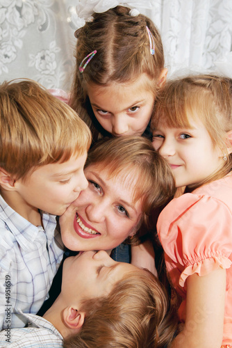 Four children kissing mother. Family concept