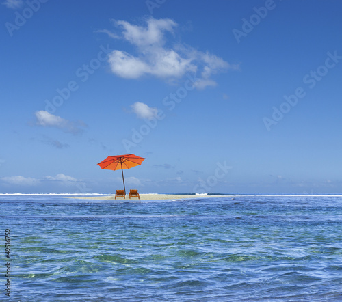 parasol sur îlot de sable blanc