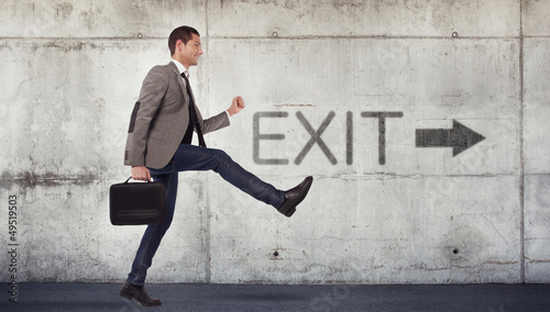 Young businessman going to the exit photo