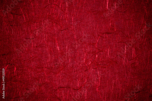 Grunge textured recycled red paper with natural fiber parts with