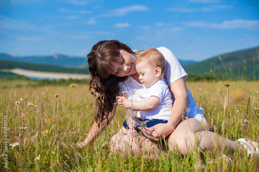 Family - happy mom and her son smiling at nature Family - happy mom and her son smiling at nature