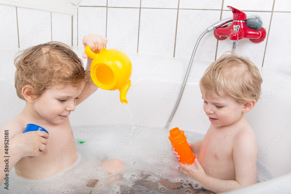 Two little boys having fun in bathtub Two little boys having fun in bathtub