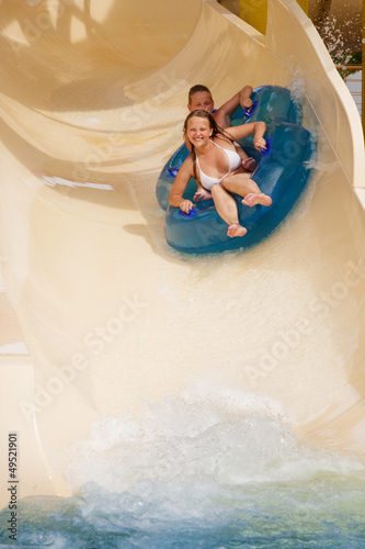 boy and girl  on water slide